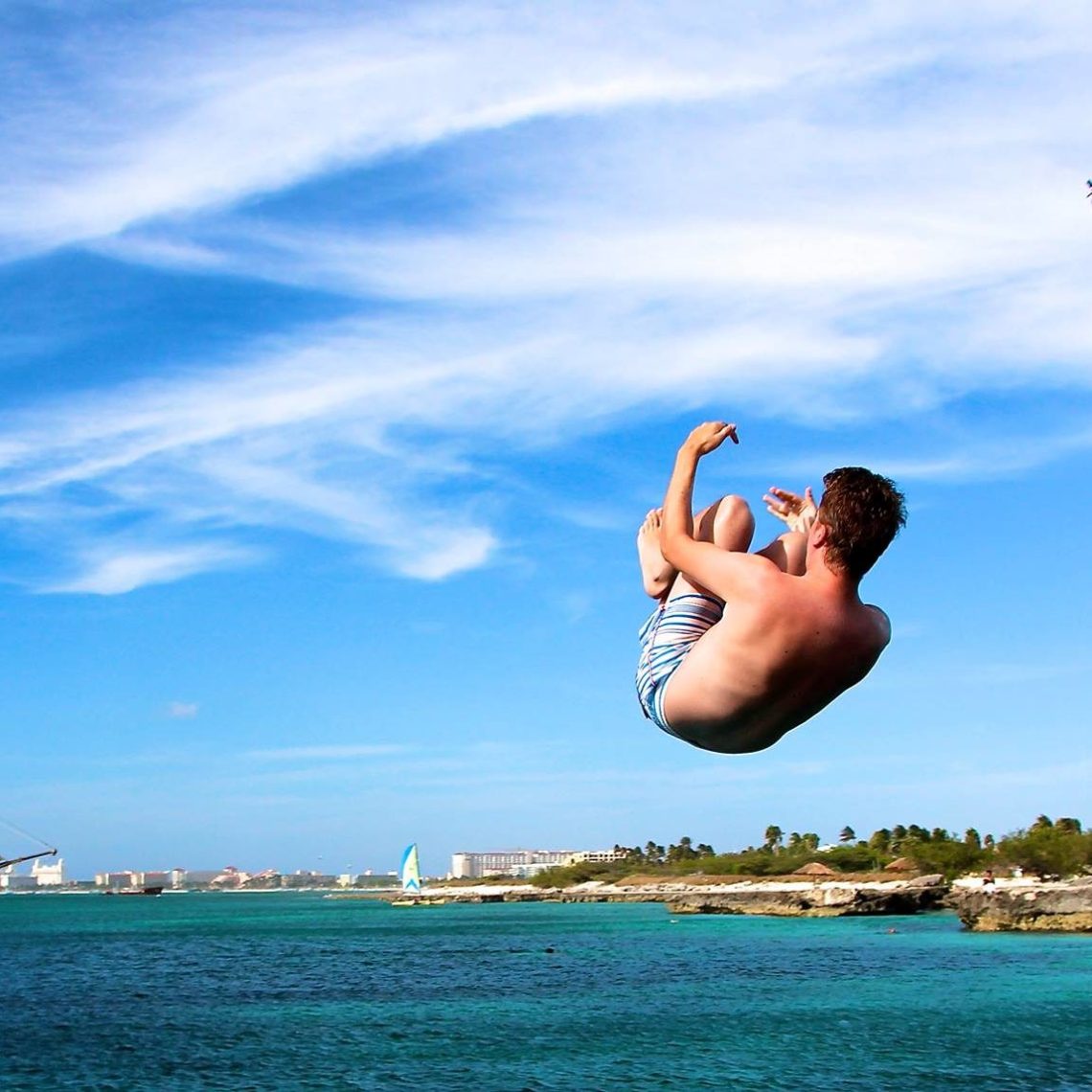 a bird flying over a body of water