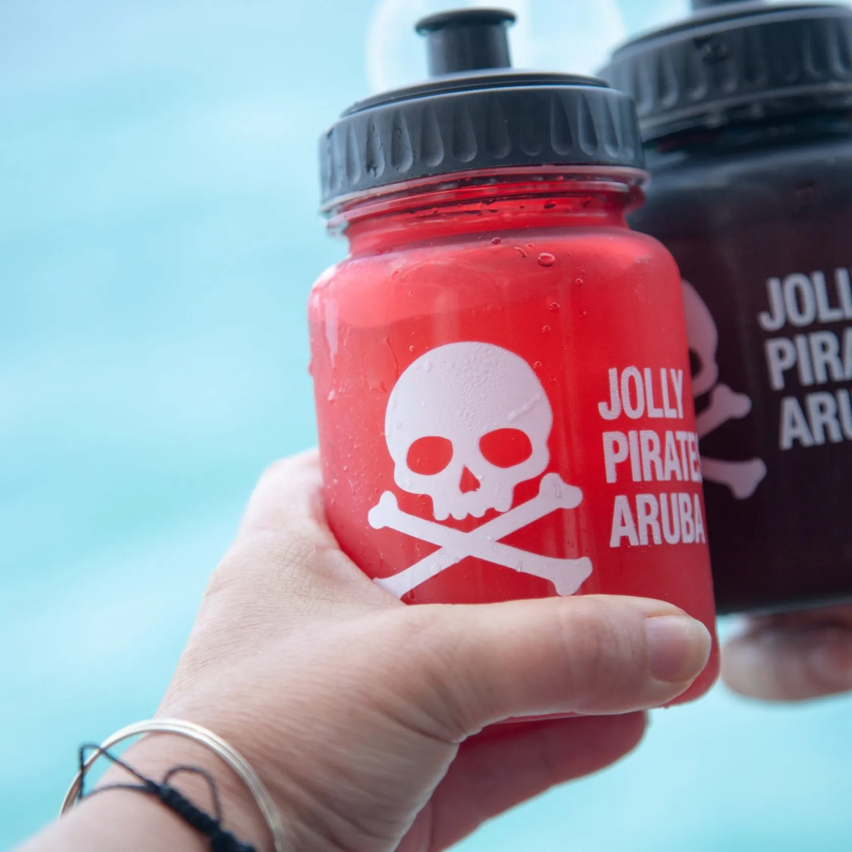 a close up of a hand holding a water bottle