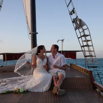 a person sitting on a dock next to a body of water