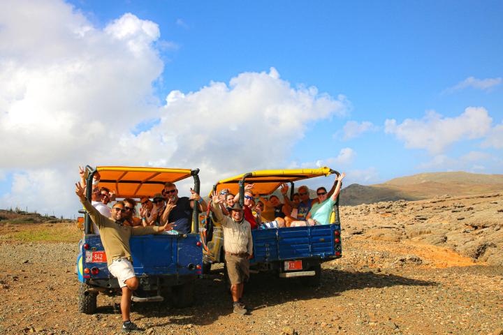 a group of people riding on the back of a truck