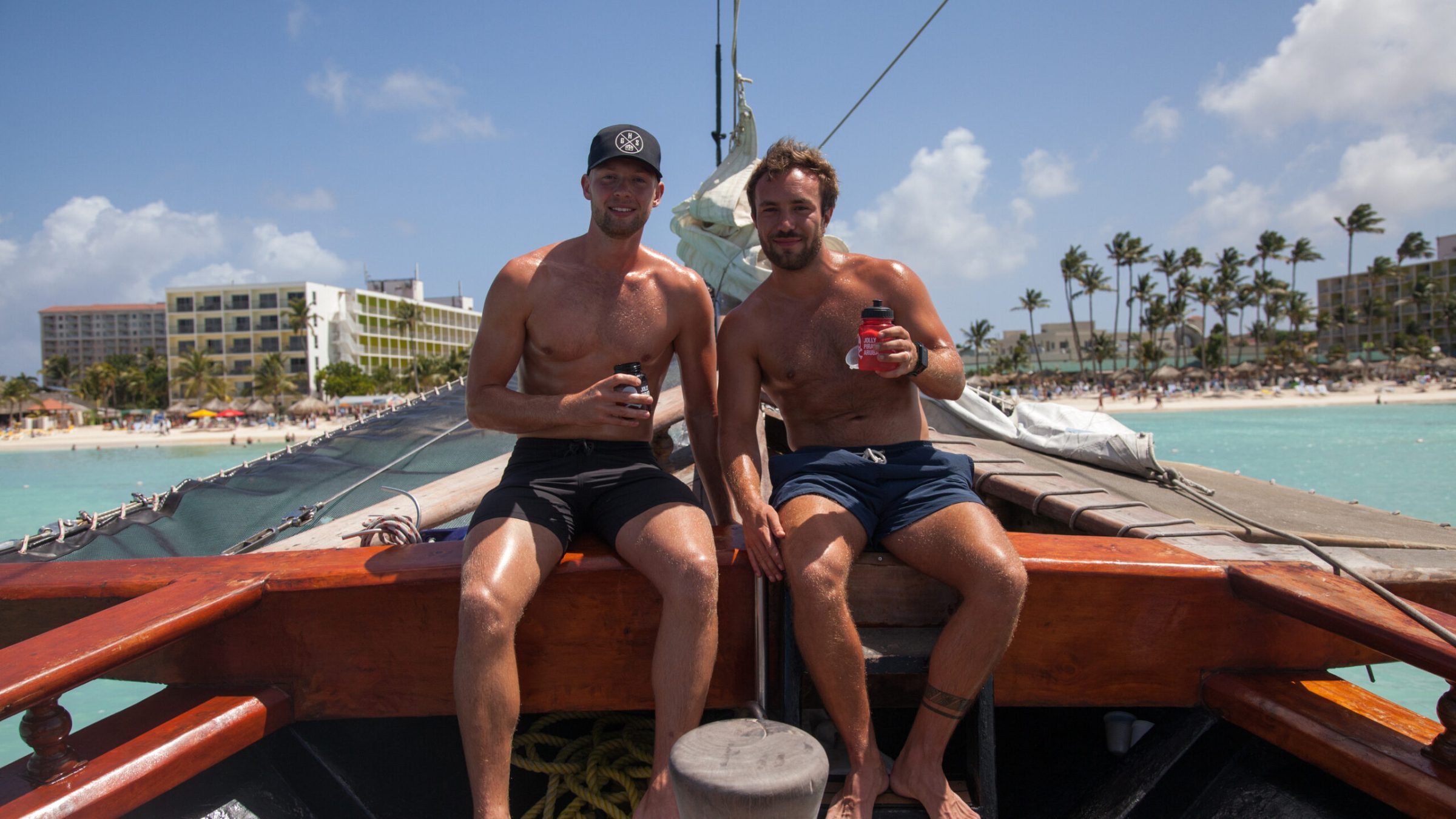 a person sitting on a bench next to a body of water