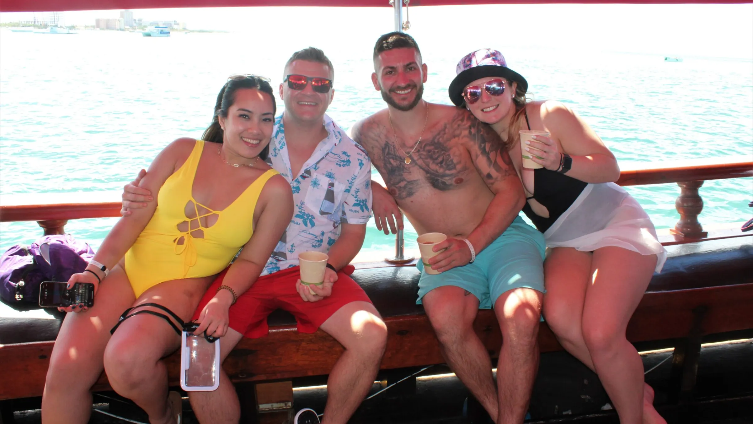 a group of people sitting on a bench posing for the camera