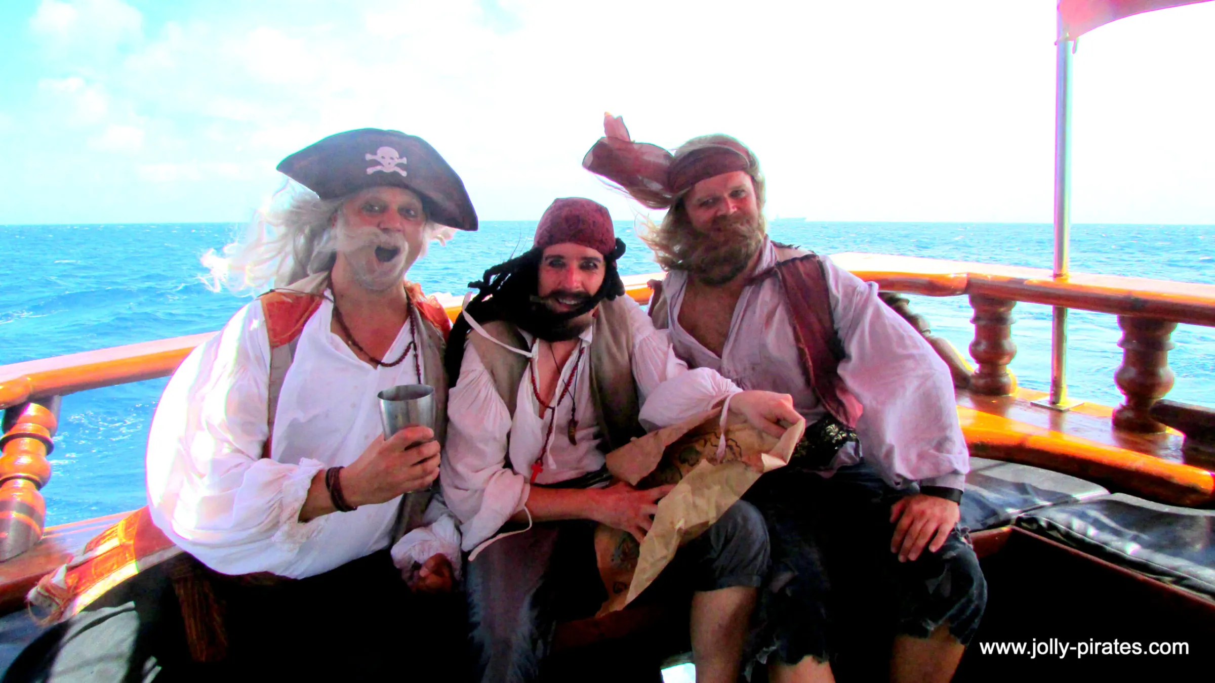 a man and woman sitting next to a body of water