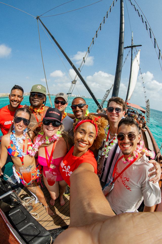 a group of people on a boat posing for the camera